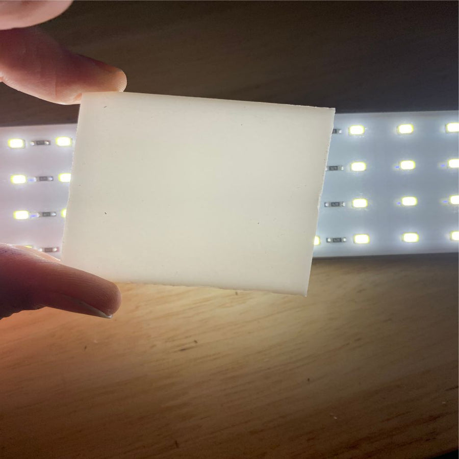 White opaque acrylic backlit with an LED strip.